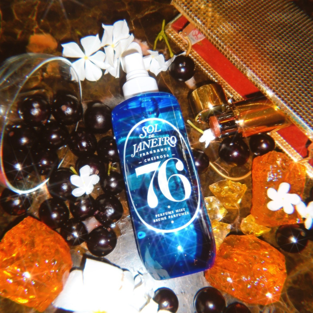 A bottle of Sol de Janeiro fragrance Cheirosa 76 Perfume Mist Brume Parfumee laying on different spices and flowers